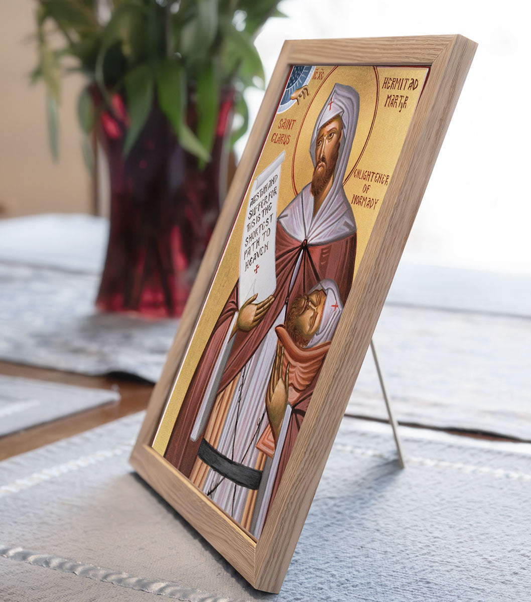 Icon of St. Clair holding a scroll and his head, featuring a cross and a blue and gold design.