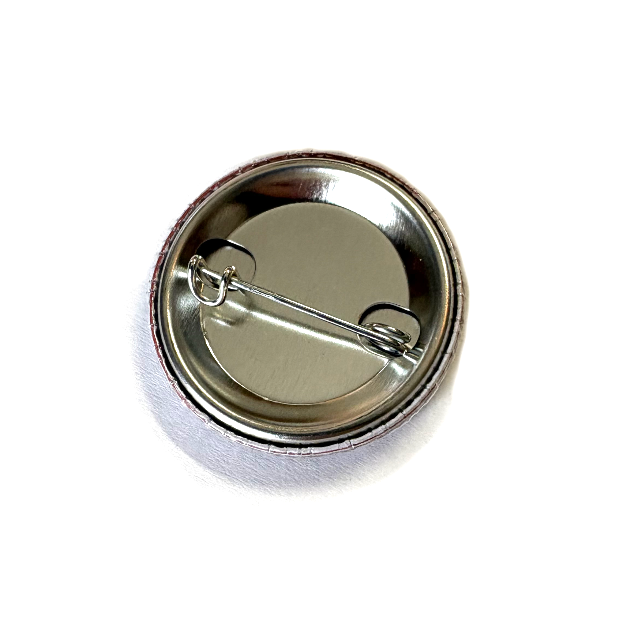 Metallic button badge on a white background