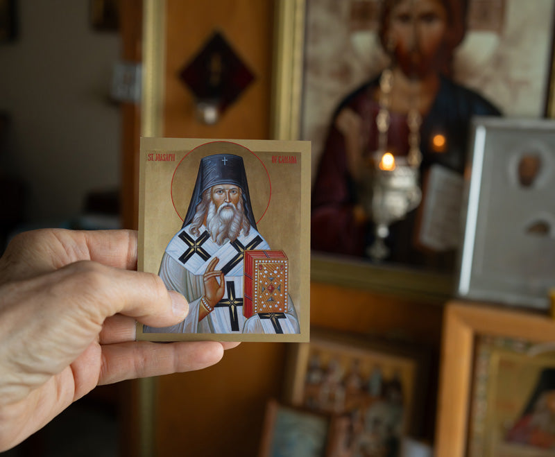 Icon of St. Joasaph holding a book and a cross, with a golden background.