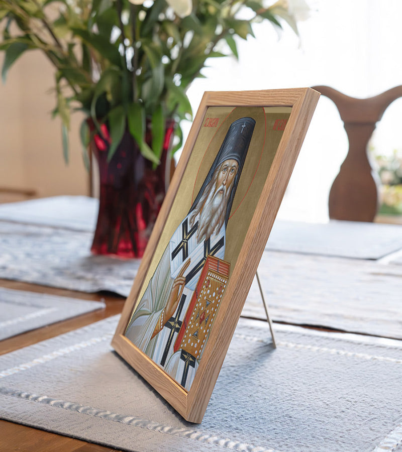 Icon of St. Joasaph holding a book and a cross, with a golden background.
