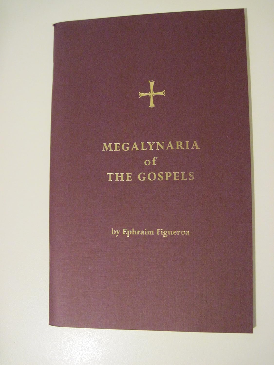 Book cover of 'Megalynaria of the Gospels' with a cross symbol on a white background