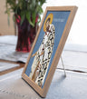 Framed religious icon on a table with a blurred background