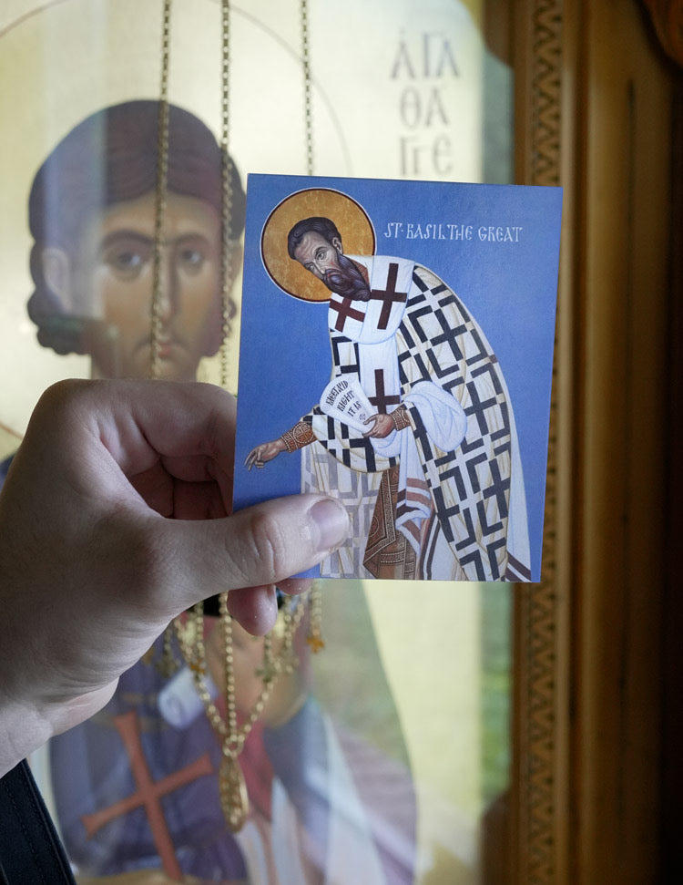 Hand holding a card with a religious icon of a Saint Basil the Great.