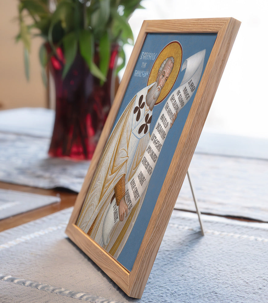 Framed religious icon with a blue background on a table