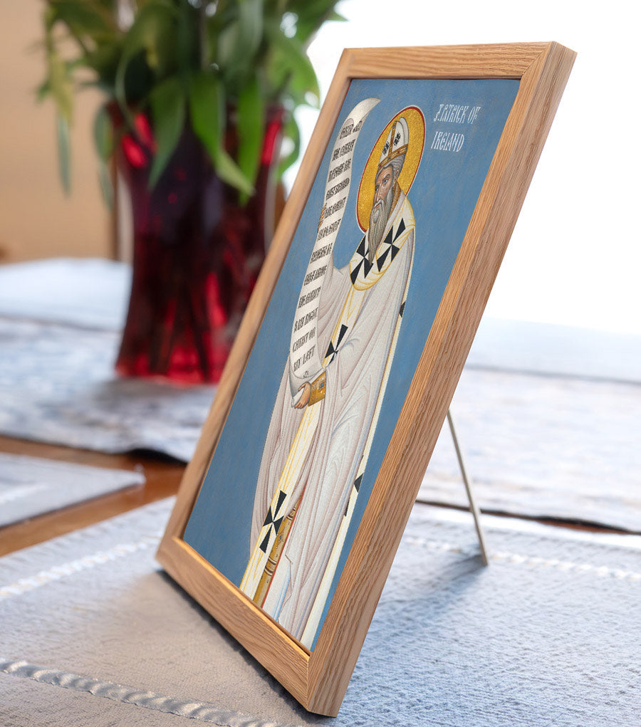 Framed icon on a table with a plant in the background