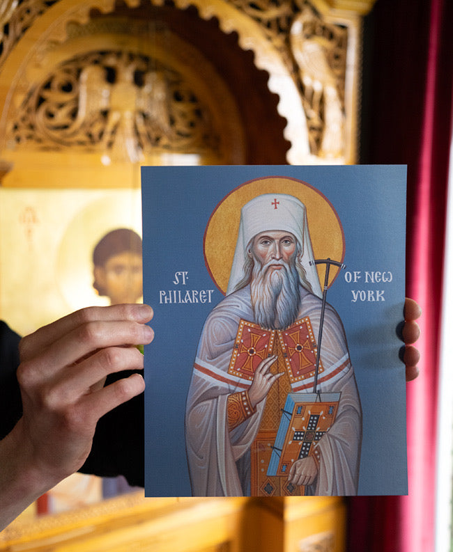 Card with an illustration of Saint Philaret held in front of a decorative background