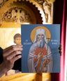 Card with an illustration of Saint Philaret held in front of a decorative background