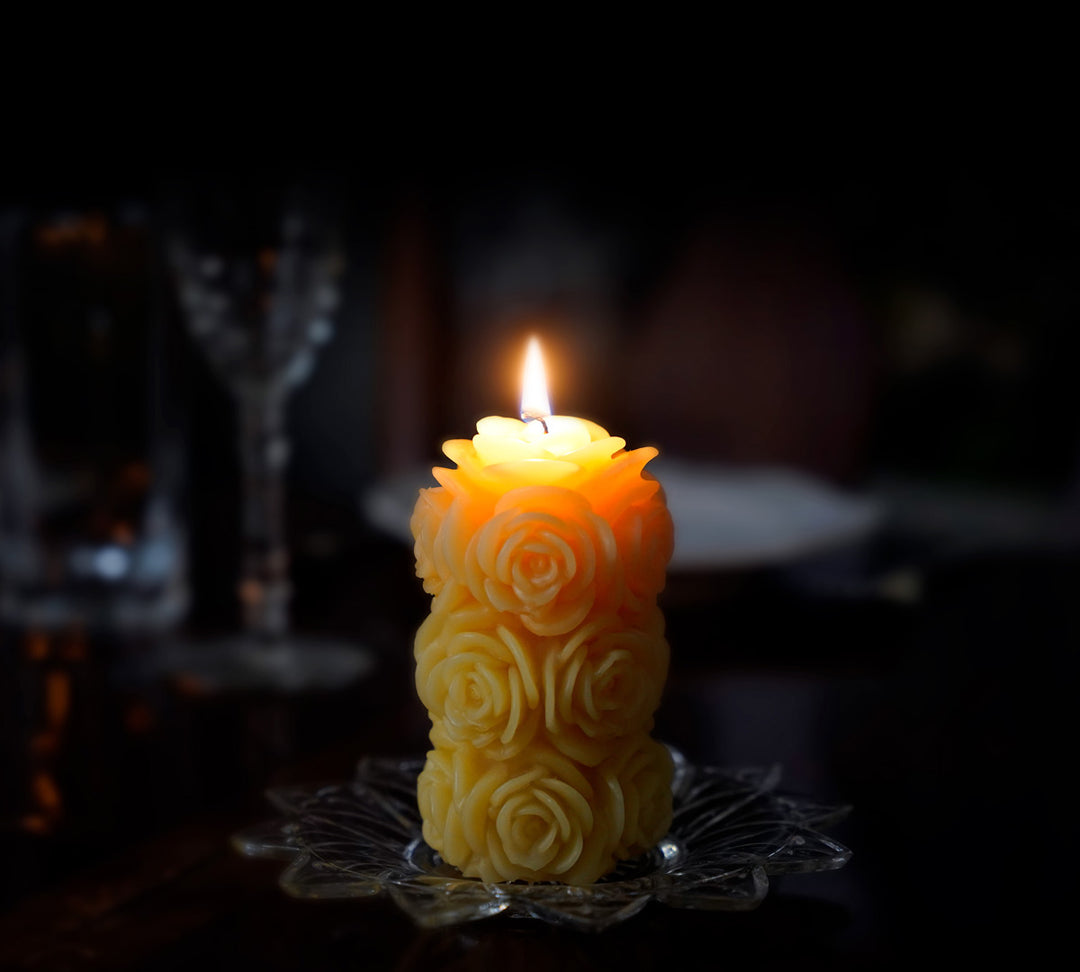 100% Pure Beeswax rose lit in a dark room